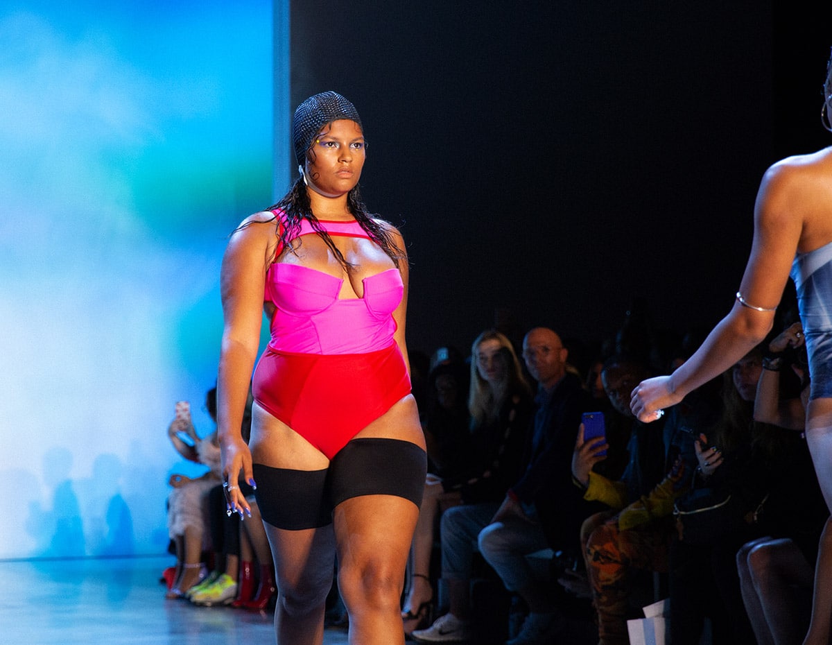 model strutting down runway wearing unisex Bandelettes® thigh bands