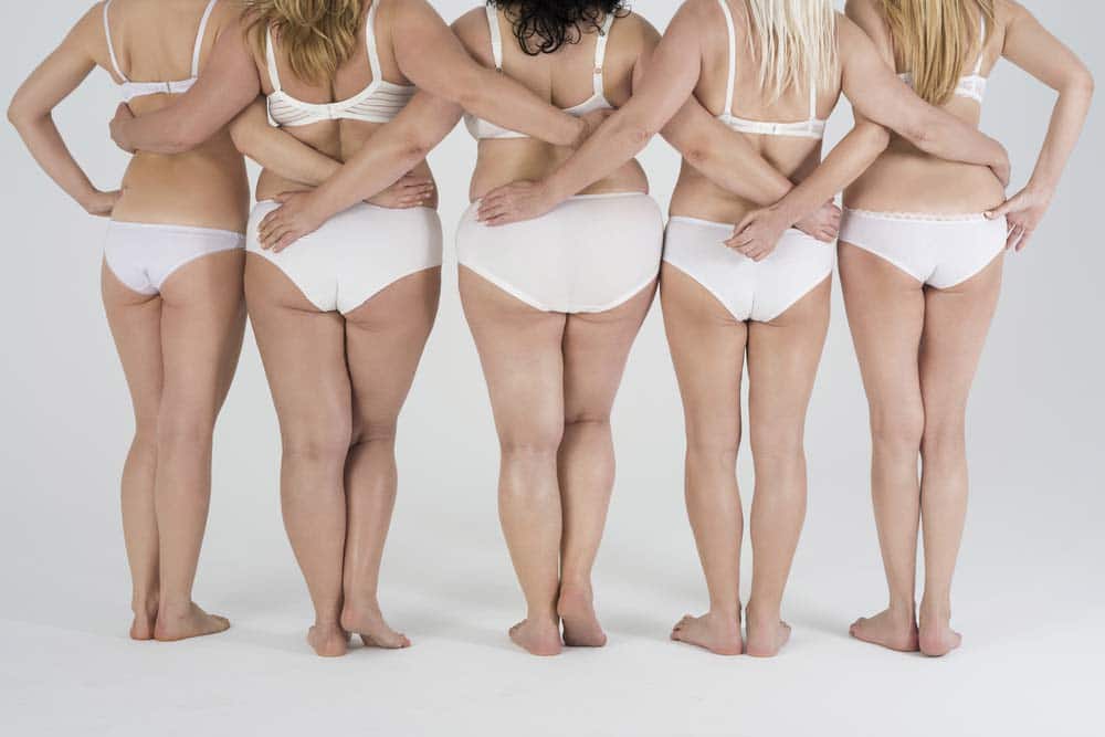 Woman of different shapes standing in row