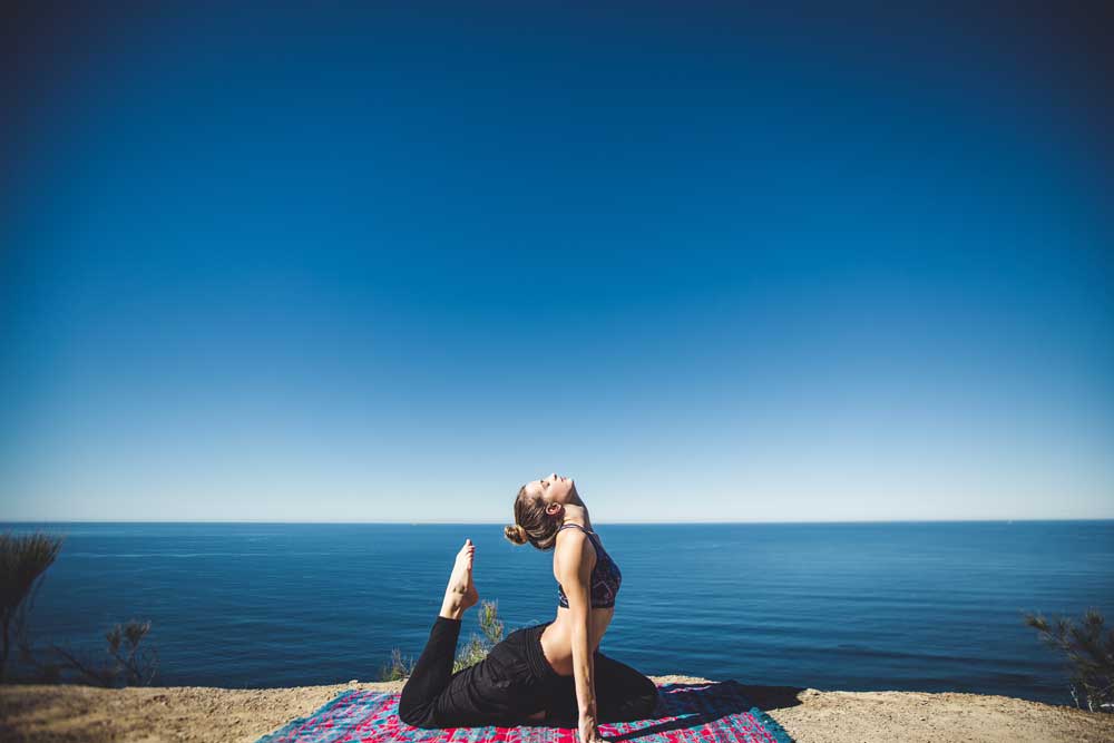 Woman exercising on the beach